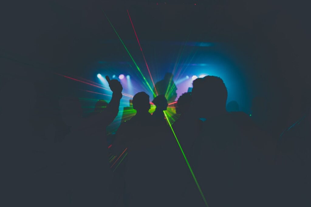 Blue and red laser with silhouettes of people