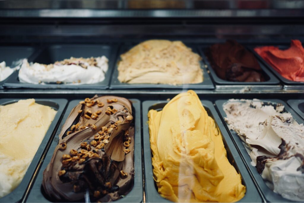 Different flavors of icecream in black trays at Farinella (Little Italy).